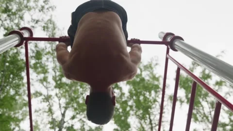 Muscular Man Performing Inverted Sit-Ups Outdoors 스톡 동영상 330921336