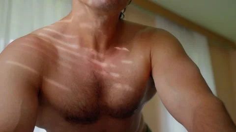 A Muscular Man Posing in Natural Light Showcasing His Toned Chest and Strong Video stock 314468199