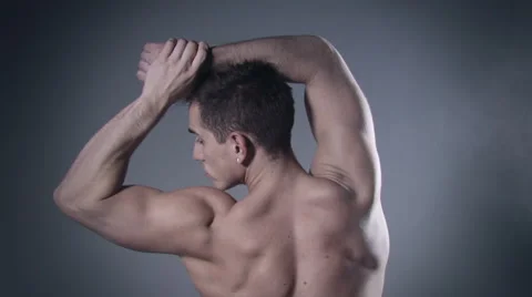 Muscular man posing in studio. Stockbeeldmateriaal 58144636