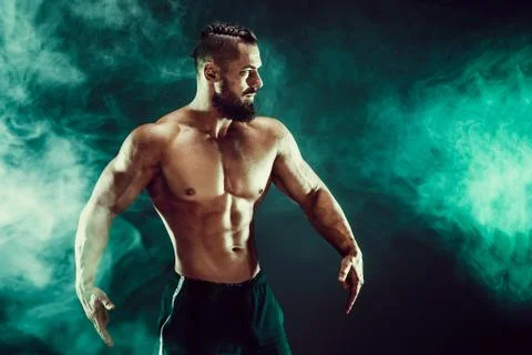Muscular man posing in studio. Stock Photos