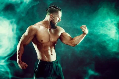 Muscular man posing in studio. Stock Photos