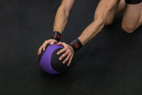 Muscular man practicing plank exercise using a ball at the gym. Stock Photos