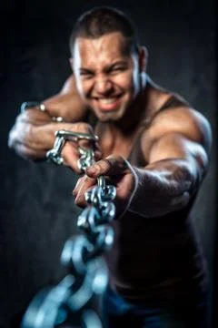 Muscular man pulling the chain Stock Photos