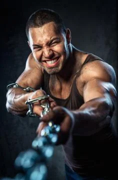 Muscular man pulling the chain Stock Photos