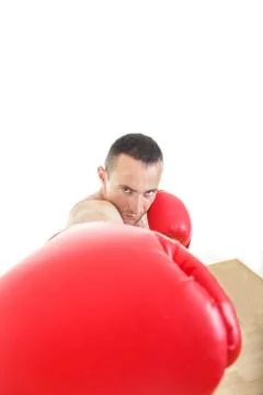 Muscular man with red  gloves hiting to camera Stock Photos