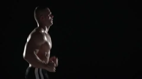 Muscular man running in profile, medium shot left Stock Footage 11524310