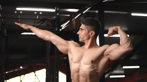 Muscular man showing off posing like bodybuilder at gym, bodybuilding Stock Footage 201404328