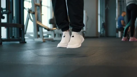 Muscular man train at gym jumping rope Stock Footage 101024392