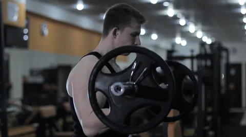Muscular man training with barbell Stock Footage 62744657