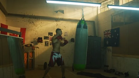 Muscular man training inside a boxing studio Stock Footage 100035027
