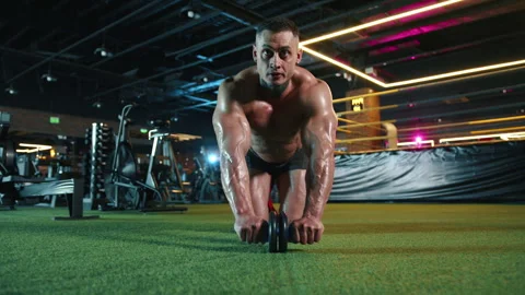 Muscular man using ab roller in gym, dedicated to fitness and strength training Stock Footage 276468794