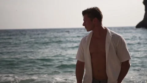 Muscular man walking on the beach Stock Footage 149145087