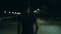 The muscular man walking in the dark street. slow motion 4k or 4k+ Resolution