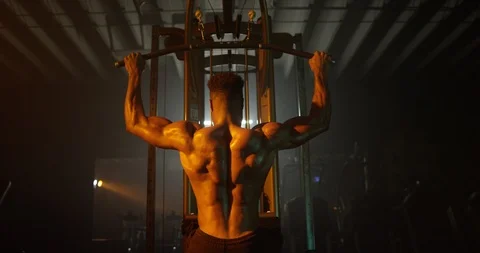 Muscular man working out with exercise equipment in the gym Stock Footage 116358803