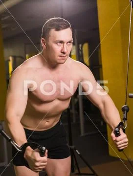 Muscular man working out in gym doing exercises, strong male naked torso abs Stock Photos