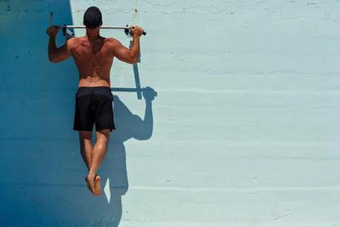 Muscular Men Doing Pull Ups Stock Photos