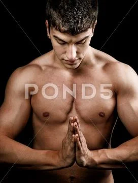 Muscular spiritual man doing yoga Stock Photos