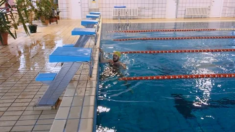 Muscular swimmer warming up and swimming distance in training. View from above. Video stock 72965853