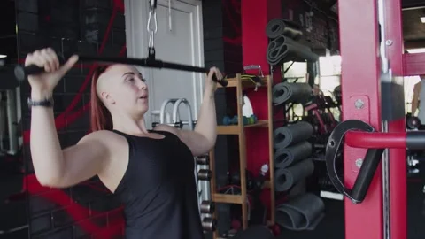 Muscular woman does Lat pulldown at gym Stock Footage 143517067