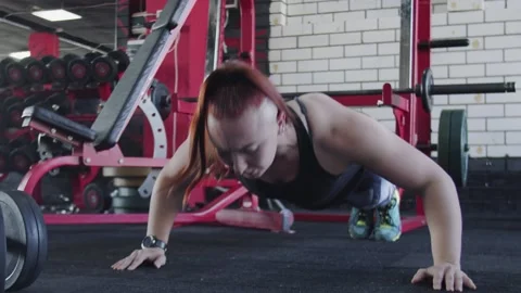 Muscular woman does Push-up exercise at gym Stock Footage 143517522