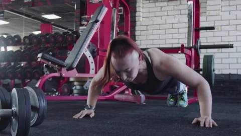 Muscular woman does Push-up exercise at gym Stock-Footage 179973015