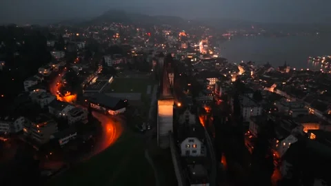 Musegg Wall and its nine towers aerial view at night overlooking glowing city in 動画素材 336750313