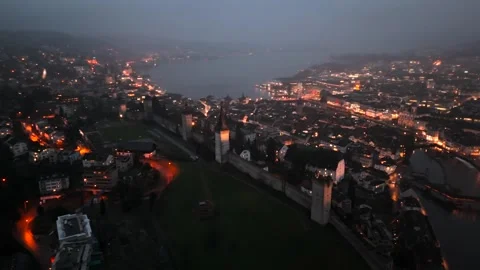 Musegg Wall and its nine towers aerial view at night overlooking glowing city in Stockbeeldmateriaal 336750832