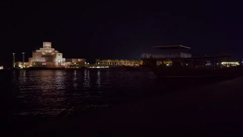 Museum of Islamic Art Doha at night with silhouette of Arab boat Видео 342903699