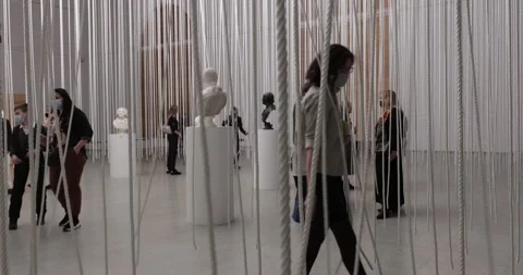 Museum visitors weared in face masks taking a tour at statue art exhibition Stock-Footage 152151938