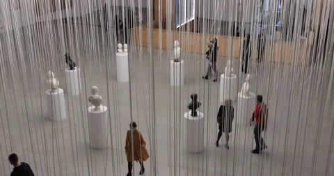 Museum visitors weared in face masks taking a tour at statue art exhibition Stock Footage 152152075