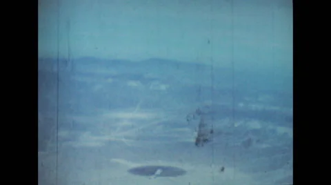 Mushroom cloud rising upwards after the atomic blast at the center of the ground Stock Footage 37592532