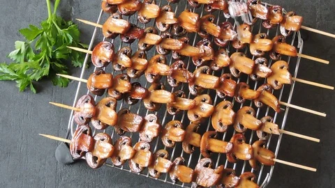 Mushroom kebab on the grill sprinkle. Stock Footage 102062399