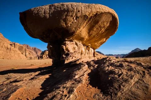 Mushroom rock casting long shadow in Wadi Rum Stock Photos