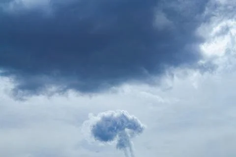 Mushroom-shaped cloud in the sky under a cloud Foto stock