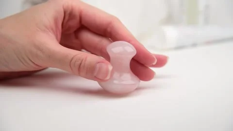 Mushroom shaped quartz stone for face and body massage. Video stock 148435544