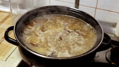Mushroom soup is boiling in a pan in the kitchen. Stock Footage 102721471