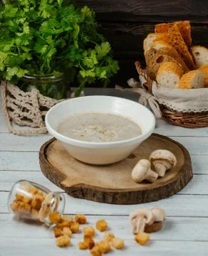 Mushroom soup served with bread stuffing on wood serving board Stock Photos
