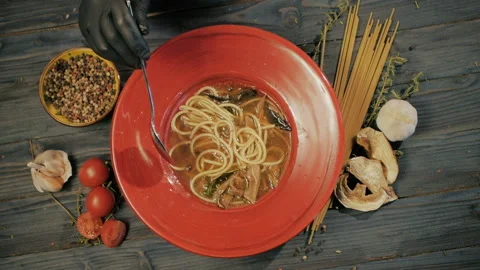 Mushroom soup with spaghetti paste. Top view. On a black wooden background. Copy Stock Footage 91670626