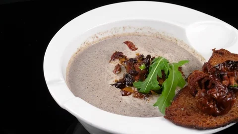 Mushroom soup with toasted bread and dried tomatoes, served in Restaurant Stock Footage 90662130