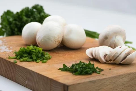 Mushrooms and herbs on a cutting board Stock Photos
