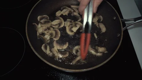 Mushrooms being cooked in pan Stock Footage 89400006