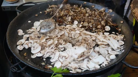 Mushrooms being sautéed in a large pan. Vídeo Stock 316796992