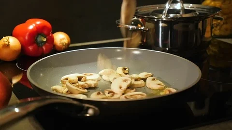 Mushrooms fall into a pan Stock Footage 70757323