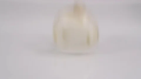 Mushrooms falling on white background into a splash of water. Filmed in slow mot Stock Footage 71452315