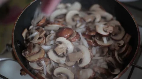 Mushrooms fried in a pan on the stove Stock Footage 59798437