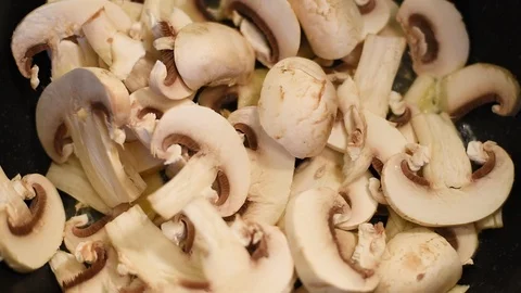 Mushrooms in the process of stewing and frying in a pan in butter Stock Footage 108204833