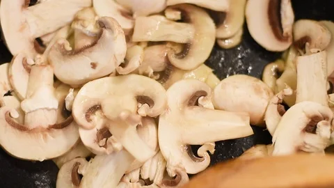 Mushrooms in the process of stewing and frying in a pan in butter Stock Footage 108204839