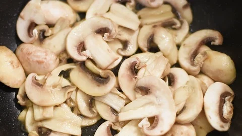 Mushrooms in the process of stewing and frying in a pan in butter Stock-Footage 108204910