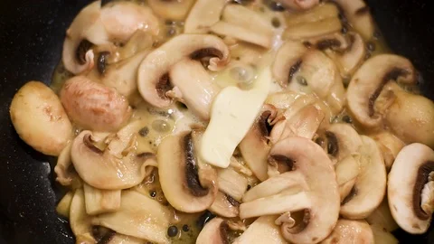Mushrooms in the process of stewing and frying in a pan in butter Stock-Footage 108204943