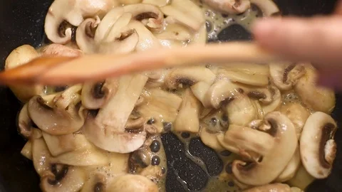 Mushrooms in the process of stewing and frying in a pan in butter Stock-Footage 108205116